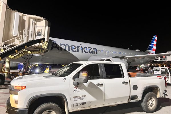 A white industrial pickup truck parked on the tarmac near an American Airlines airplane at night, with a jet bridge connected to the aircraft, highlights the crucial role of rural electric support in airport operations. A white industrial pickup truck parked on the tarmac near an American Airlines airplane at night, with a jet bridge connected to the aircraft, highlights the crucial role of rural electric support in airport operations.